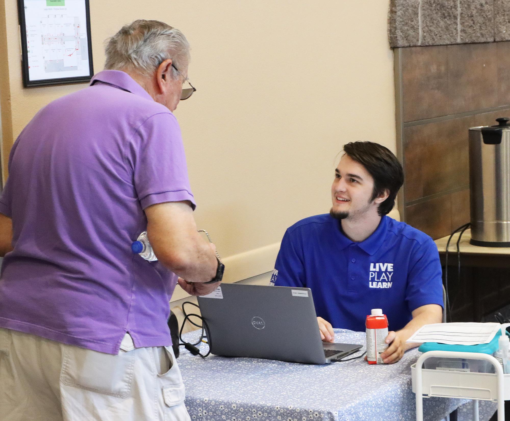 Recreation staff assisting at senior program