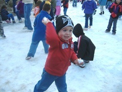 Impish youth throwing snowball